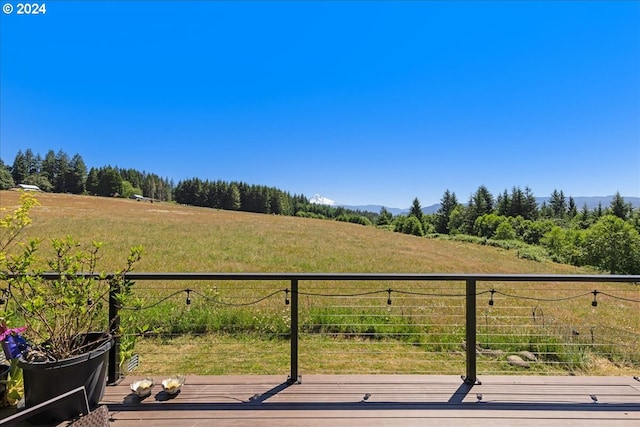 wooden terrace featuring a rural view