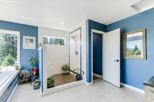 bathroom with tile patterned floors, plenty of natural light, and shower with separate bathtub