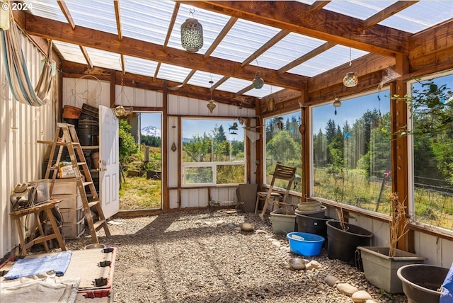 sunroom / solarium featuring a wealth of natural light and lofted ceiling