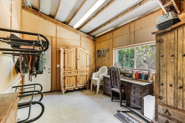 misc room with wooden walls and vaulted ceiling