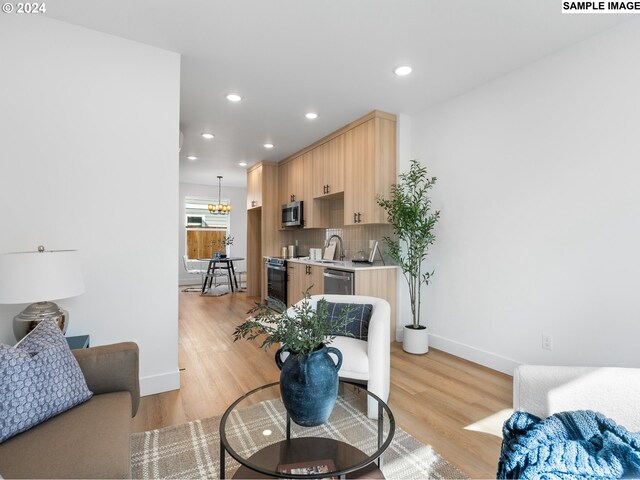 living room featuring light hardwood / wood-style flooring and sink