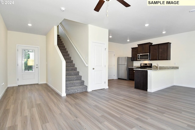 kitchen featuring ceiling fan, sink, stainless steel appliances, and light hardwood / wood-style floors