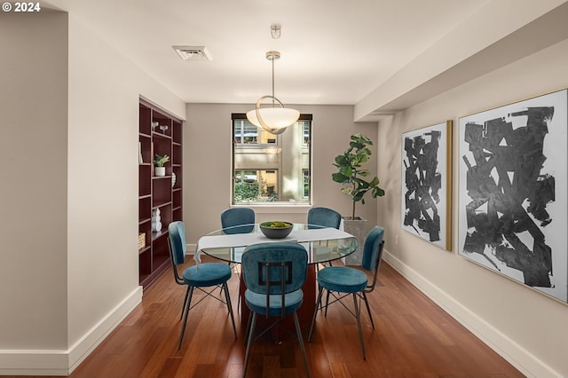 dining space featuring dark wood-type flooring