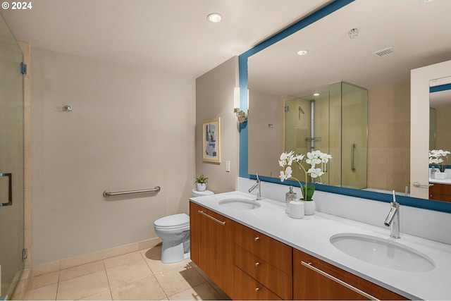 bathroom featuring walk in shower, tile patterned flooring, toilet, and dual bowl vanity