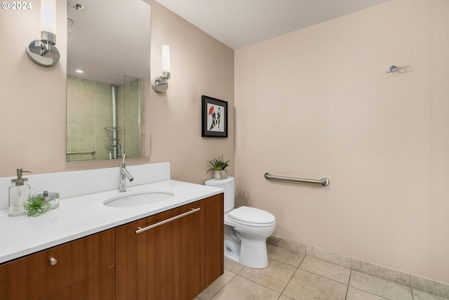 bathroom featuring vanity, tile patterned flooring, and toilet