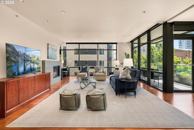 living room featuring wood-type flooring and floor to ceiling windows