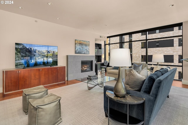 living room with floor to ceiling windows and light wood-type flooring