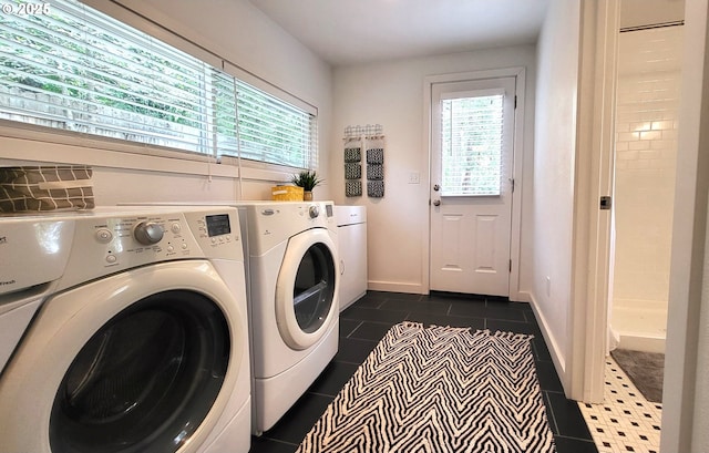 1400 W 40th St, Eugene, OR 97405 - laundry room featuring washer and dryer, dark tile patterned flooring, and baseboards