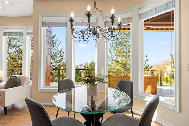 sunroom / solarium featuring an inviting chandelier