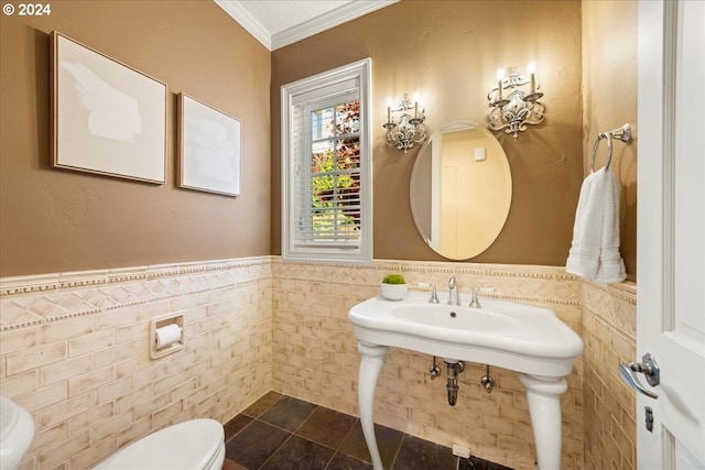 bathroom with toilet, tile walls, and crown molding