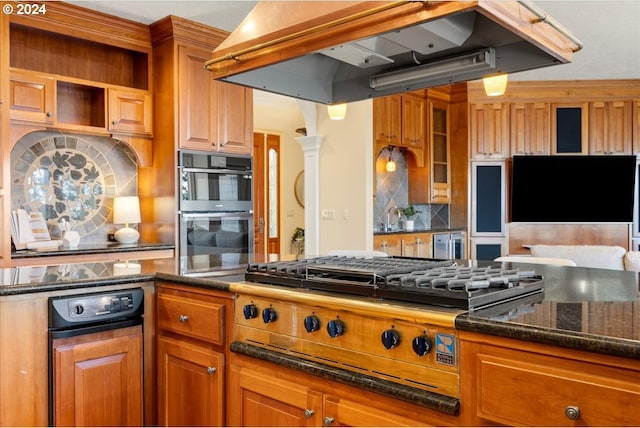 kitchen with stainless steel appliances, dark stone countertops, sink, tasteful backsplash, and premium range hood