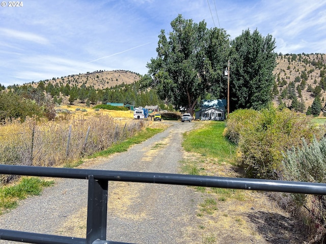 view of street featuring driveway and a mountain view