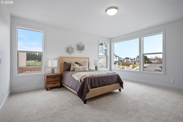 carpeted bedroom featuring multiple windows