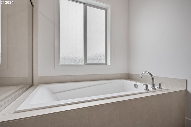 bathroom featuring tiled bath