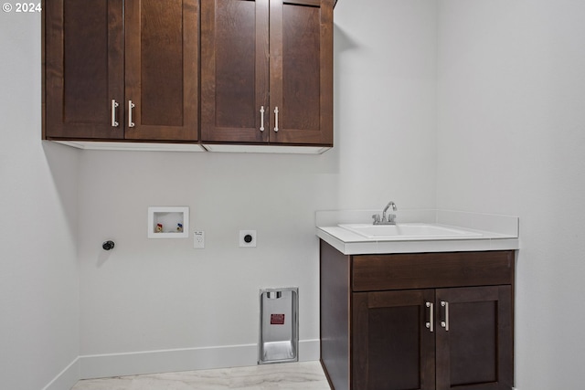 clothes washing area featuring washer hookup, hookup for an electric dryer, cabinets, and sink