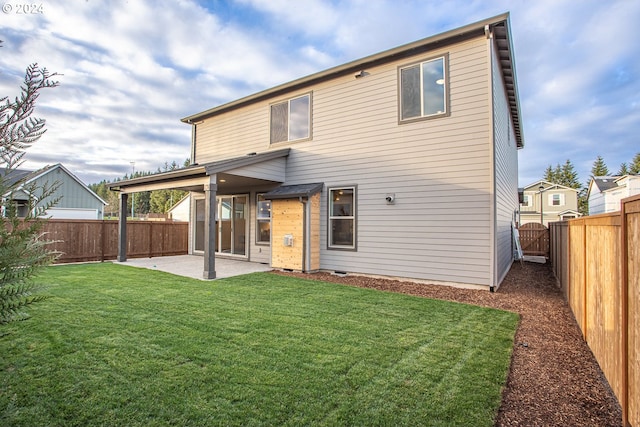 back of property with a patio and a yard