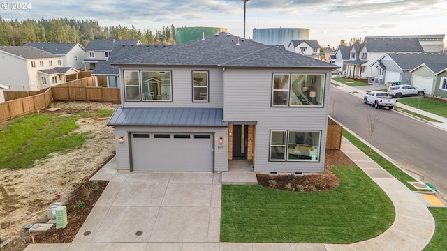 view of front facade featuring a front lawn and a garage