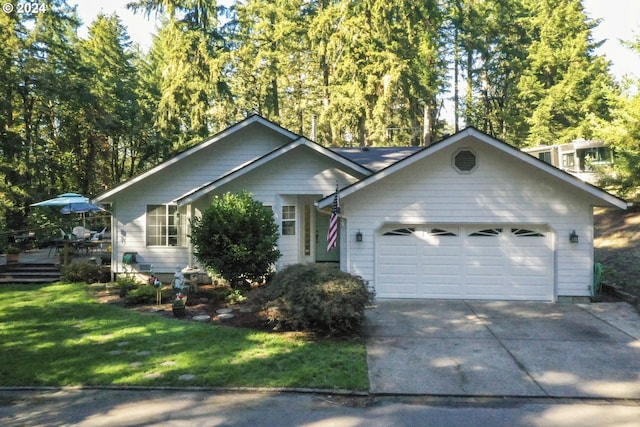 view of front of property with a front yard and a garage