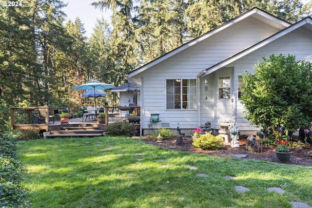 exterior space with a lawn and a wooden deck