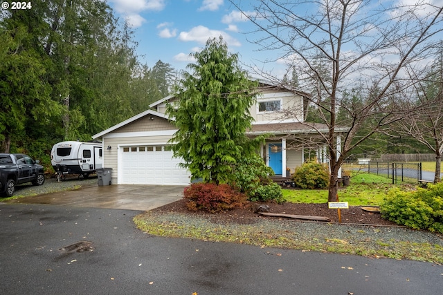 view of property hidden behind natural elements with a porch and a garage