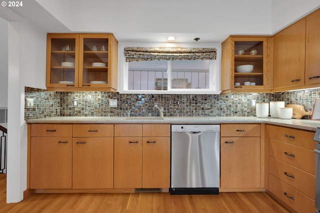 kitchen with dishwasher, decorative backsplash, light wood-type flooring, and sink