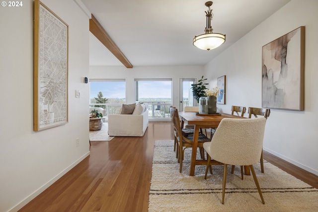 dining area with hardwood / wood-style floors and beam ceiling