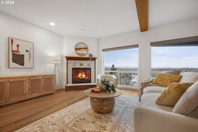 living room with beam ceiling and light hardwood / wood-style flooring