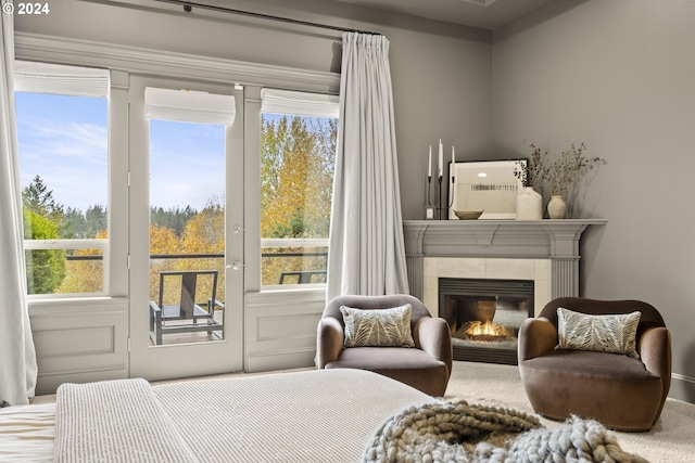 bedroom with carpet and a tiled fireplace