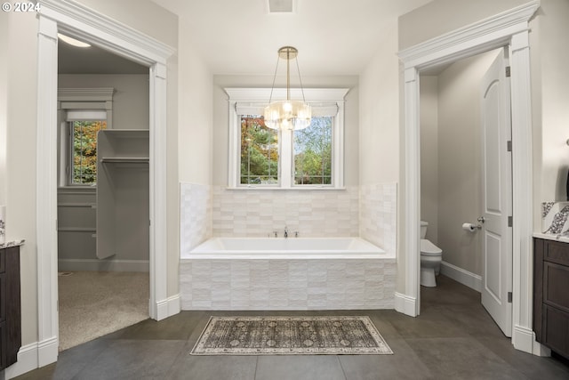 bathroom featuring a chandelier, vanity, and a healthy amount of sunlight