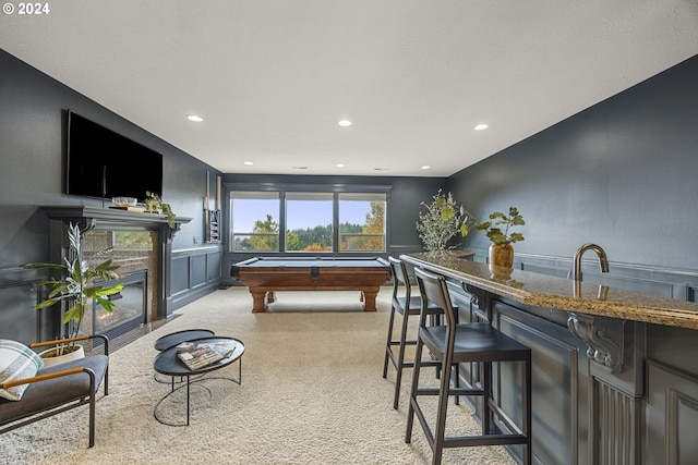 recreation room featuring light colored carpet, pool table, and bar area