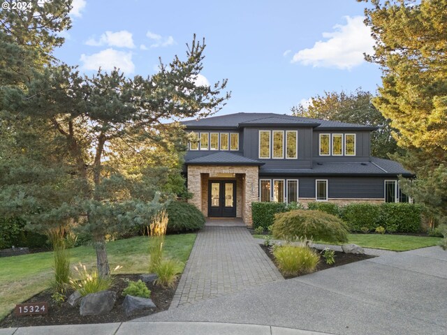 view of front facade with a front yard and french doors