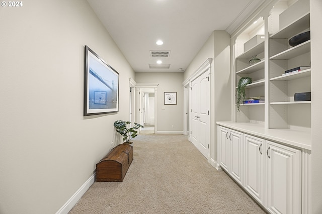 hallway featuring light carpet