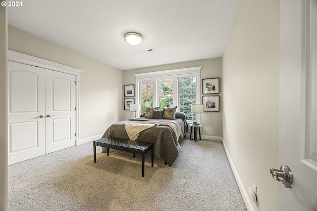 carpeted bedroom featuring a textured ceiling