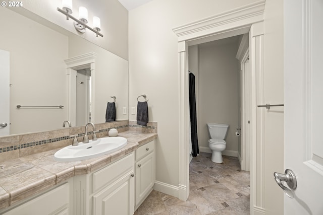 bathroom featuring toilet and vanity