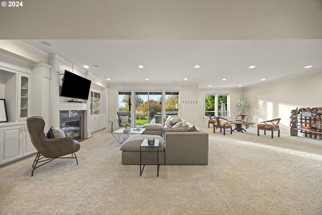 carpeted living room featuring ornamental molding