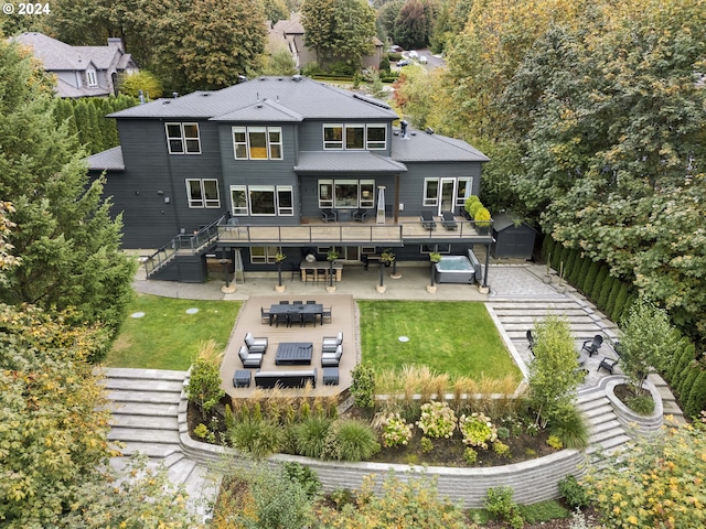 rear view of property with a patio, outdoor lounge area, and a lawn