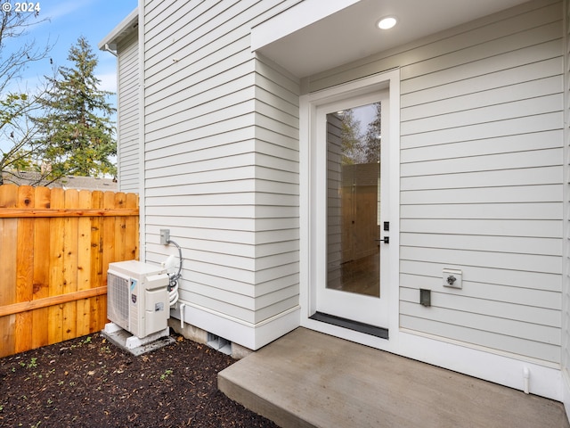 doorway to property featuring ac unit