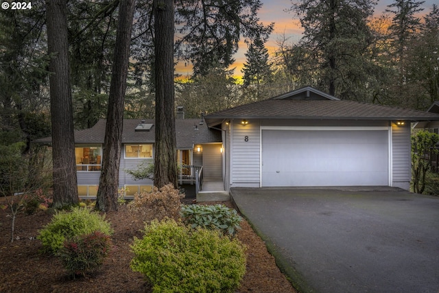 view of front of property with a porch and a garage