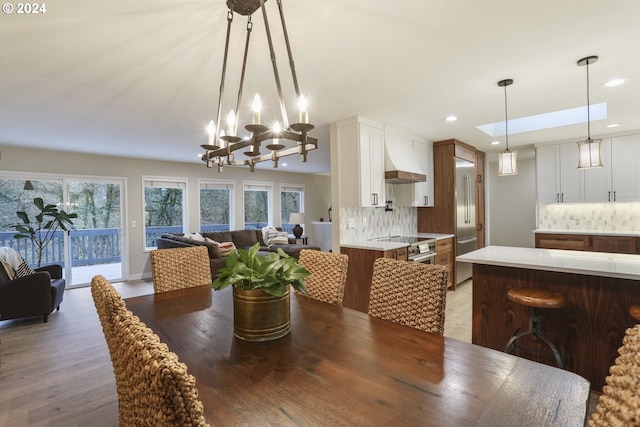 dining room featuring hardwood / wood-style flooring and an inviting chandelier