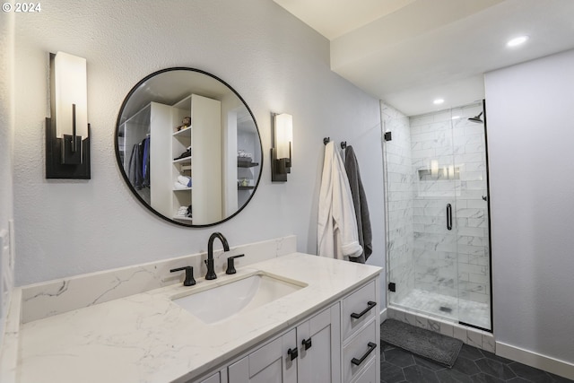 bathroom with tile patterned floors, vanity, and walk in shower