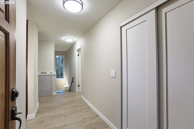 corridor with light hardwood / wood-style flooring