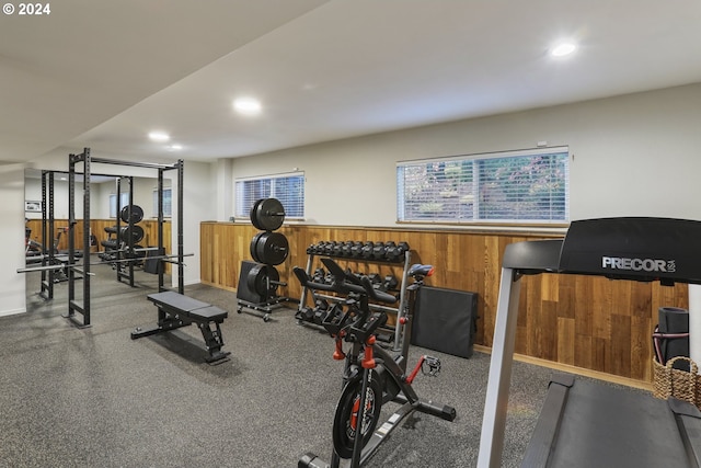 workout room featuring wood walls