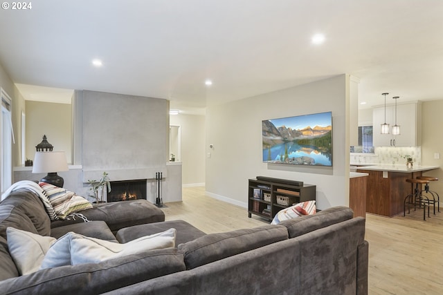 living room with a fireplace and light hardwood / wood-style floors