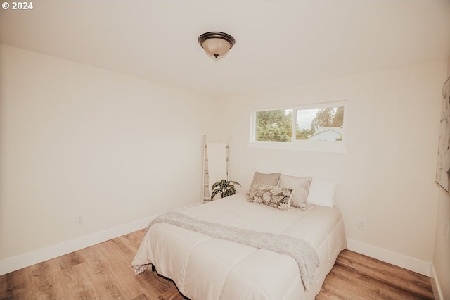 bedroom with hardwood / wood-style floors