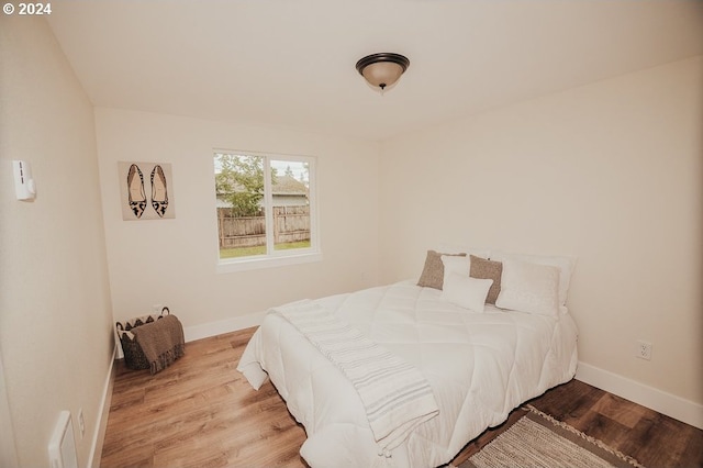 bedroom with hardwood / wood-style flooring