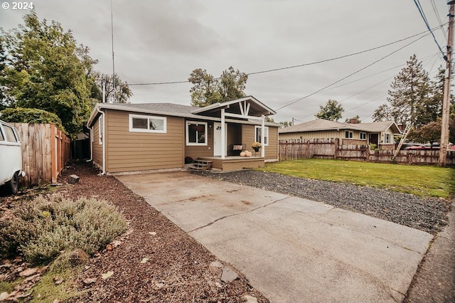 rear view of property featuring a yard and a patio