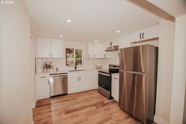 kitchen featuring appliances with stainless steel finishes, sink, and white cabinetry