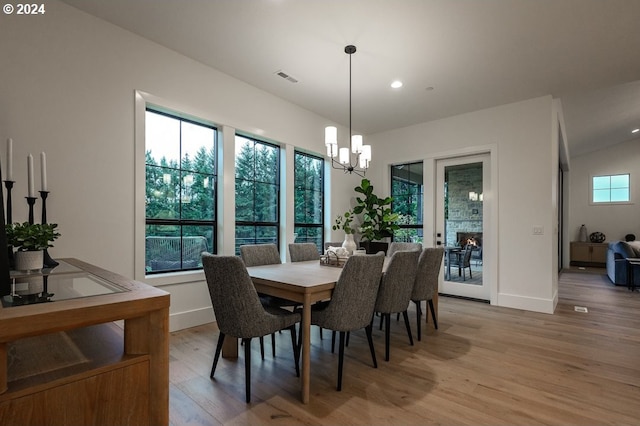 dining area with a wealth of natural light and light hardwood / wood-style floors