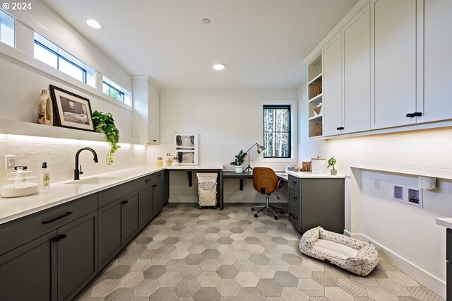 interior space featuring backsplash, sink, and a wealth of natural light