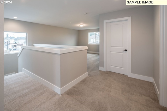 corridor with light colored carpet